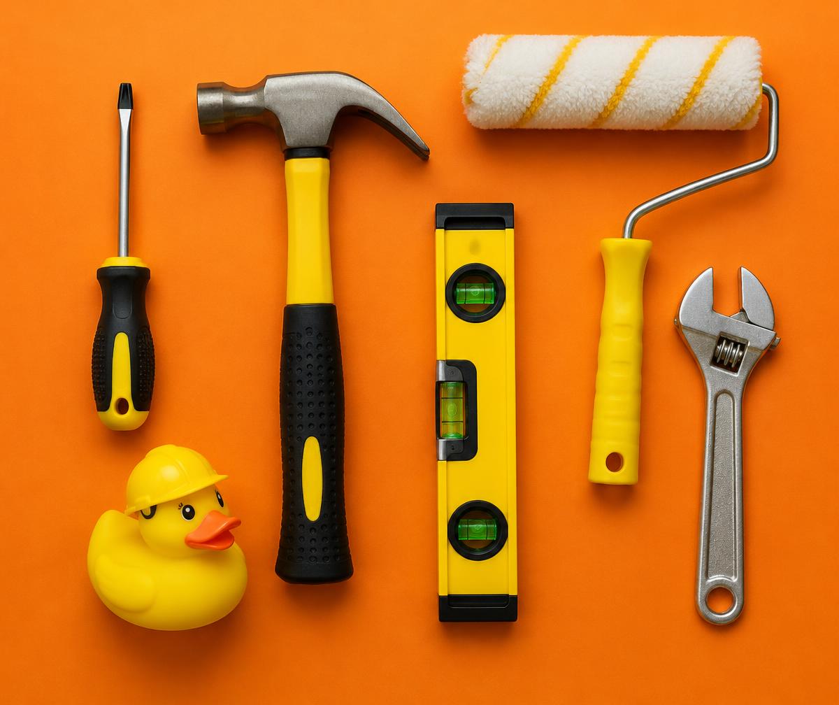 Handyman tools and a rubber duck in a hard hat